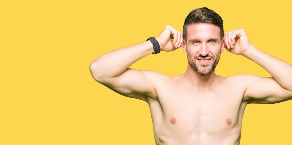 White Man Holds Out Ears with Shirt Off in Front of Yellow Background